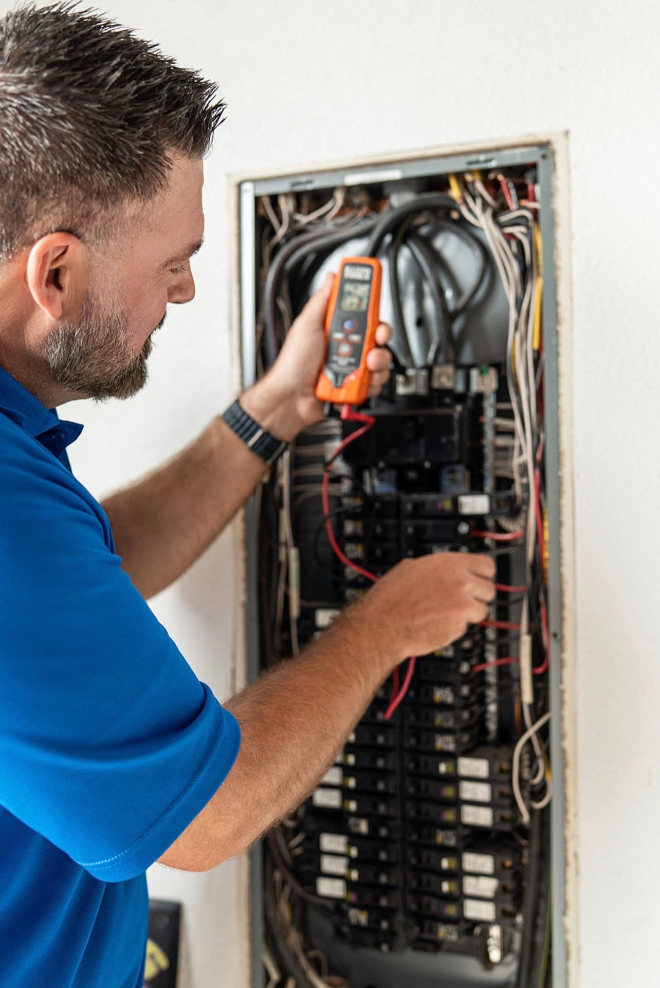 An Allsafe Electric electrician testing a residential breaker panel in a Parker home
