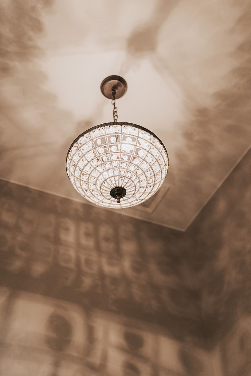 A decorative bowl chandelier lit after installation