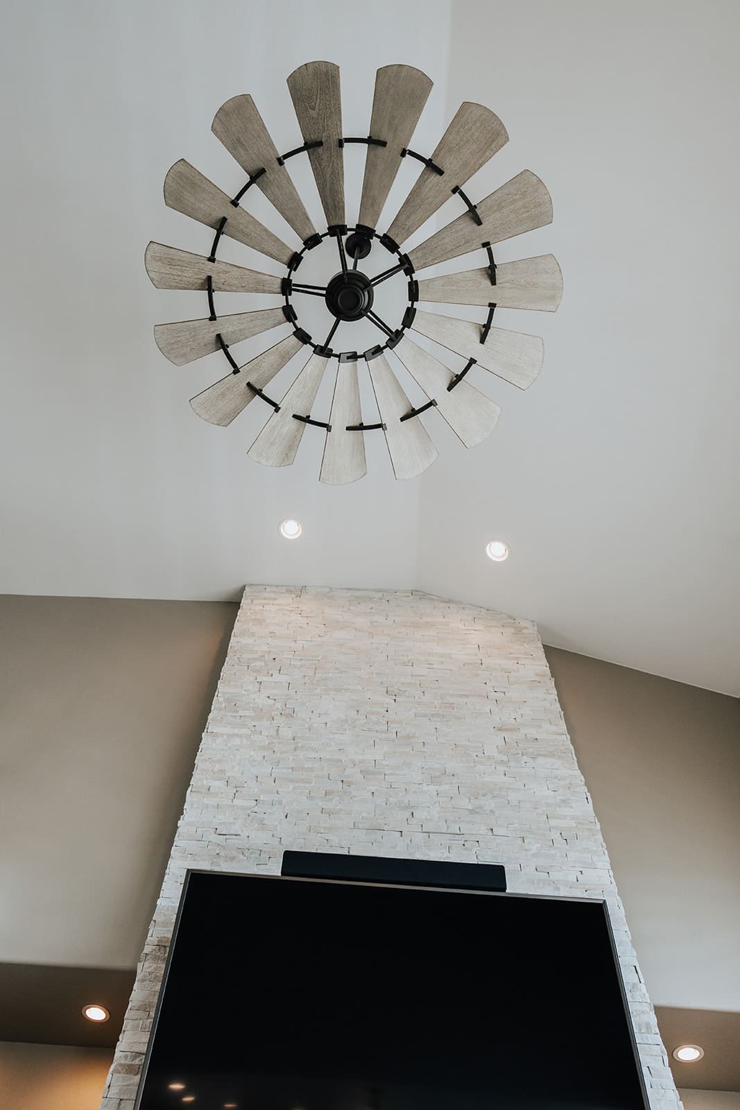 A large windmill-style ceiling fan installed in a living room